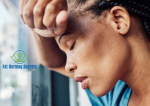 African-American doctor challenging negative thinking leaning against a glass window with eyes closed.